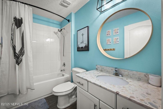 bathroom with vanity, visible vents, a textured ceiling, toilet, and shower / tub combo with curtain