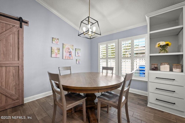 dining area featuring dark wood-style floors, baseboards, ornamental molding, and a chandelier