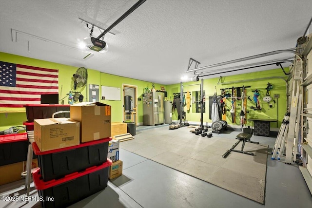 garage featuring a garage door opener and stainless steel refrigerator with ice dispenser