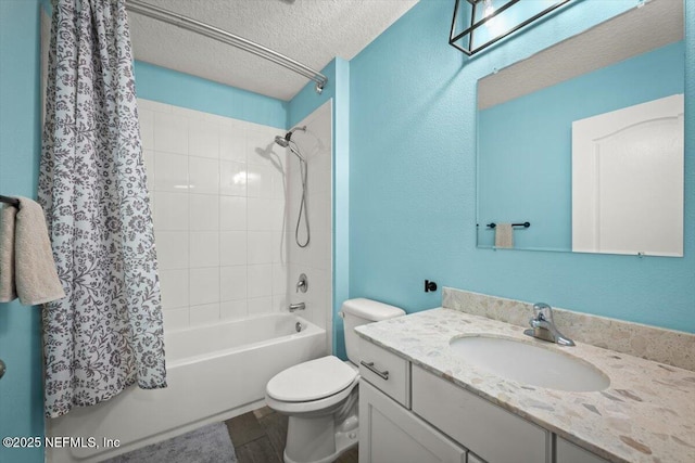 full bath featuring vanity, wood finished floors, shower / bath combo, a textured ceiling, and toilet