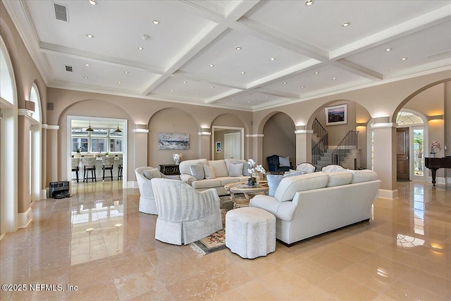 living area featuring visible vents, coffered ceiling, arched walkways, stairs, and beamed ceiling