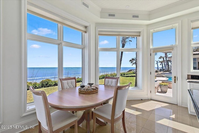 sunroom featuring visible vents, a water view, and plenty of natural light