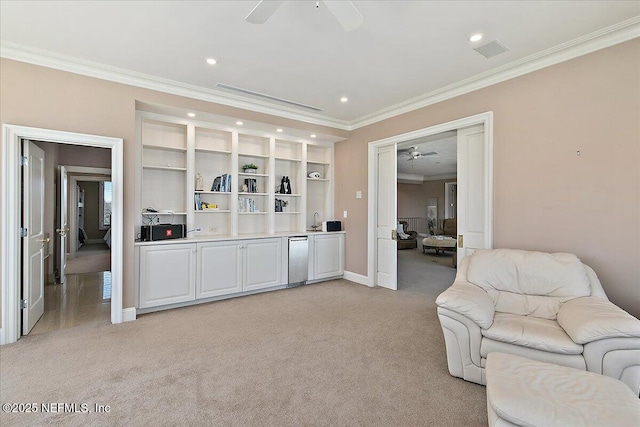 interior space with open floor plan, light colored carpet, crown molding, and ceiling fan