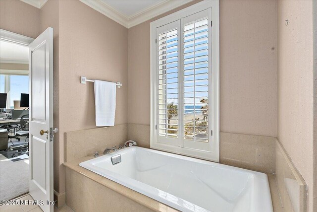 bathroom featuring ornamental molding, tile patterned flooring, and a bath