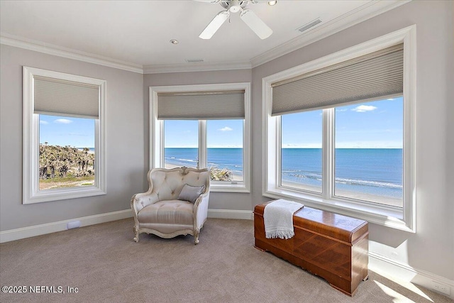 living area featuring visible vents, crown molding, baseboards, a water view, and light colored carpet