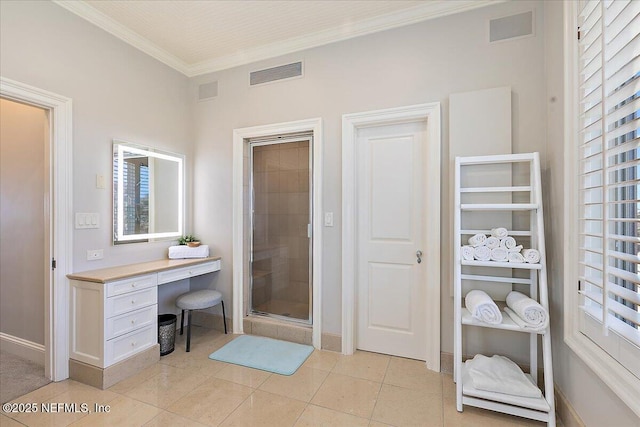 bathroom featuring baseboards, visible vents, a stall shower, ornamental molding, and tile patterned flooring