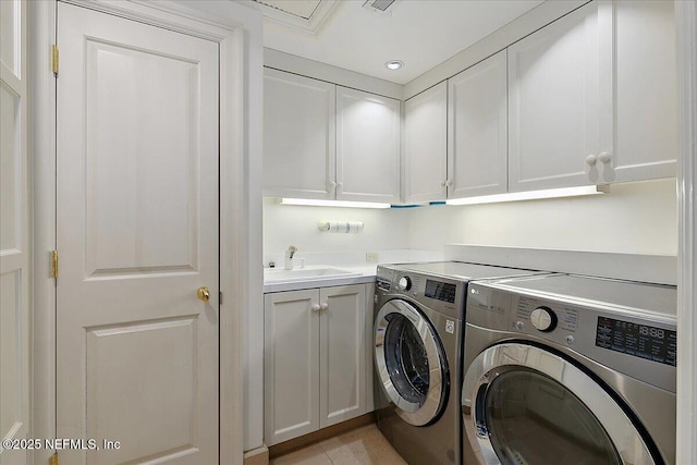 laundry room with a sink, recessed lighting, cabinet space, and washer and clothes dryer