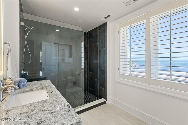 full bath featuring a shower stall, baseboards, and visible vents