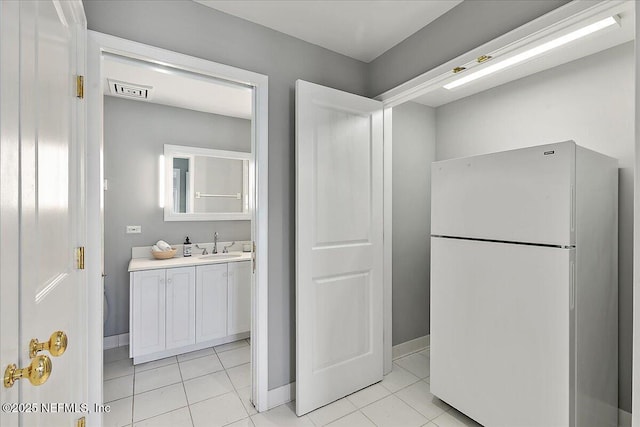 bathroom featuring vanity, tile patterned floors, baseboards, and visible vents