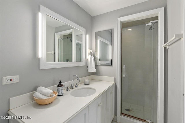 bathroom with a shower stall and vanity