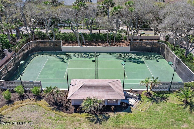 view of tennis court featuring fence