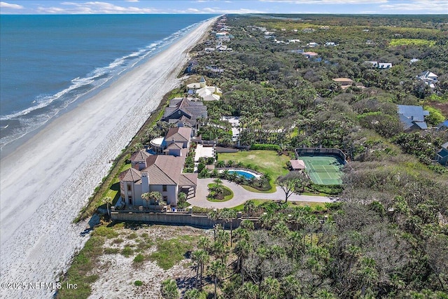 birds eye view of property featuring a beach view and a water view