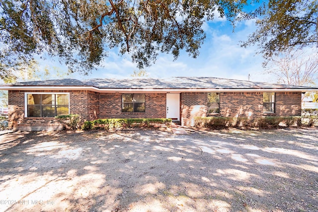 single story home featuring brick siding