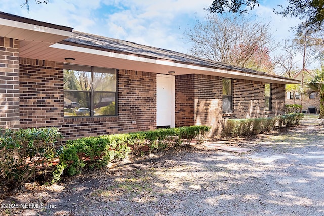 exterior space featuring brick siding