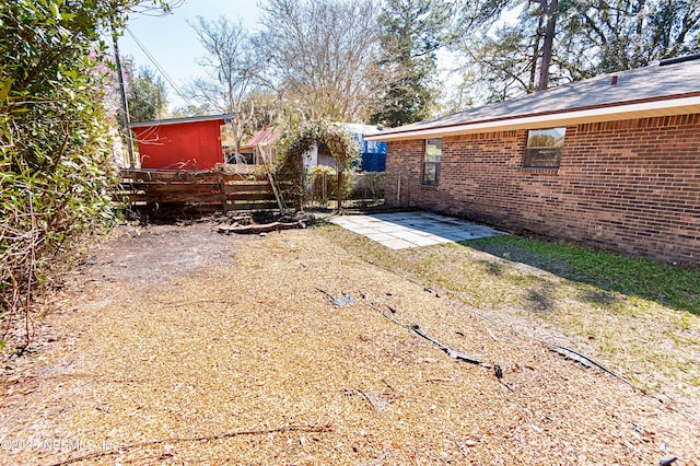 view of yard with a patio and fence