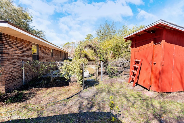 view of yard featuring an outdoor structure and fence