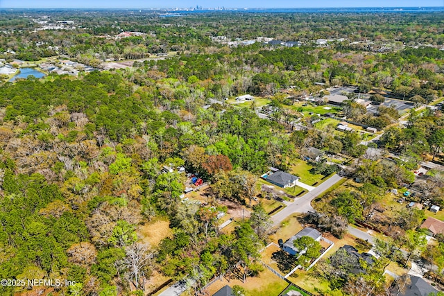 birds eye view of property with a forest view and a water view