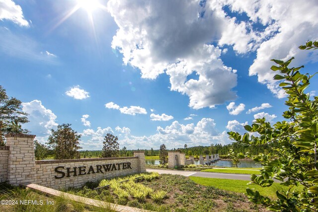 community sign featuring a water view