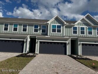 view of front of property with driveway, board and batten siding, and an attached garage