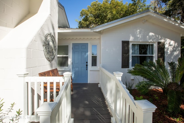 entrance to property featuring concrete block siding