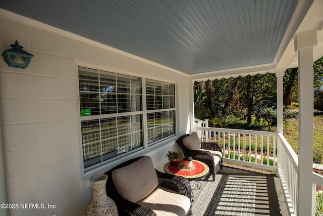 balcony with covered porch and a sunroom