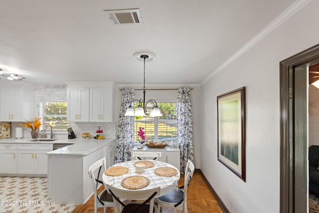 dining room featuring a notable chandelier, visible vents, and ornamental molding