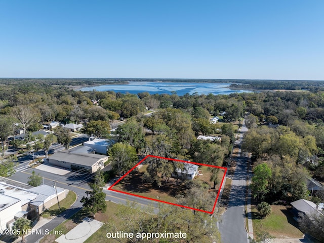 aerial view featuring a water view and a wooded view