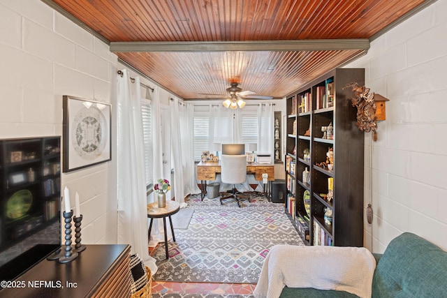 home office with wood ceiling, ceiling fan, and concrete block wall