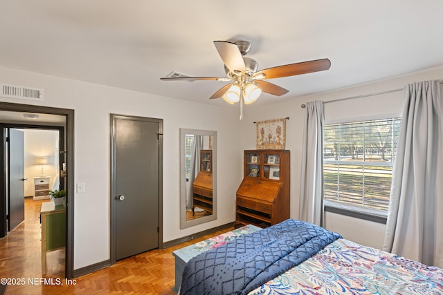 bedroom featuring visible vents, baseboards, and a ceiling fan