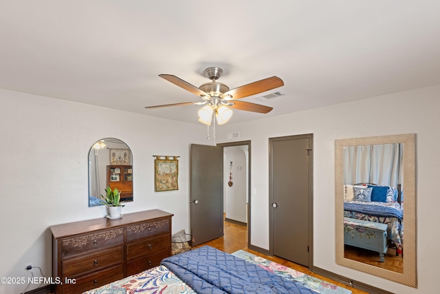 bedroom with visible vents and a ceiling fan