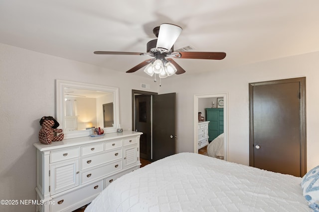 bedroom with a ceiling fan, visible vents, and ensuite bathroom