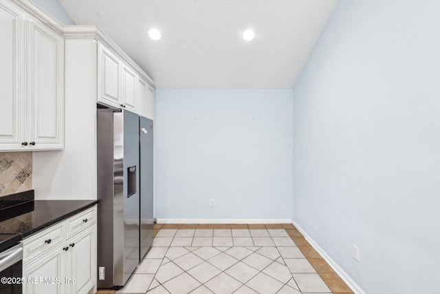 kitchen featuring backsplash, recessed lighting, stainless steel fridge, and white cabinetry