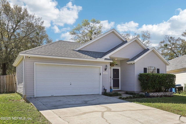 ranch-style home with concrete driveway, fence, a garage, and a shingled roof