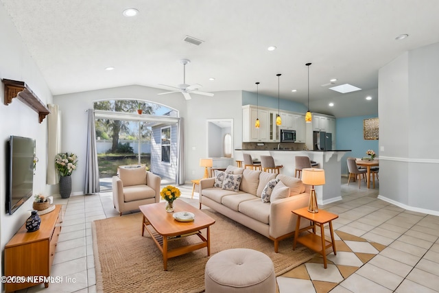 living area with light tile patterned flooring, visible vents, a ceiling fan, and lofted ceiling