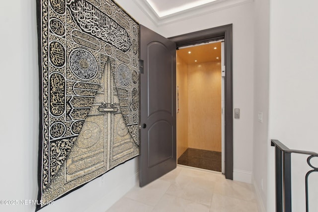hallway featuring elevator, baseboards, and ornamental molding
