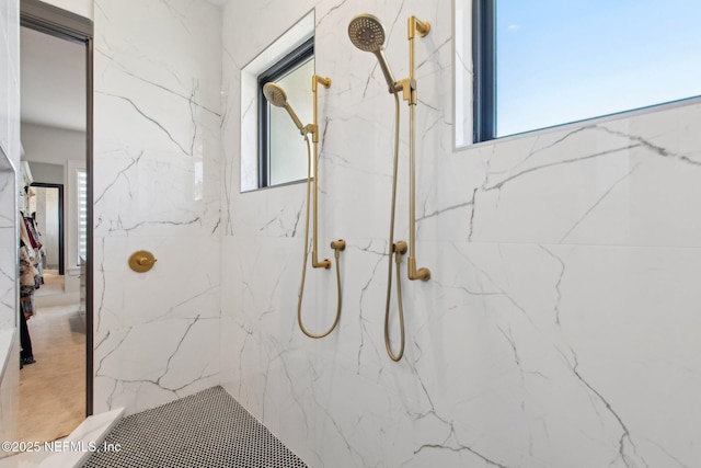 full bathroom featuring a marble finish shower