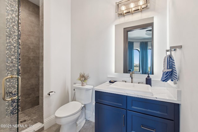 full bathroom featuring baseboards, vanity, toilet, and a shower stall
