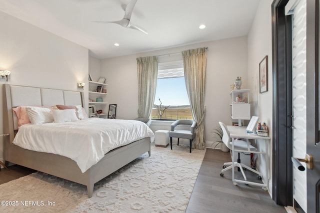 bedroom with a ceiling fan, recessed lighting, wood finished floors, and baseboards