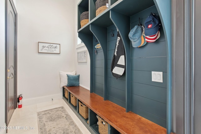 mudroom with tile patterned floors and baseboards