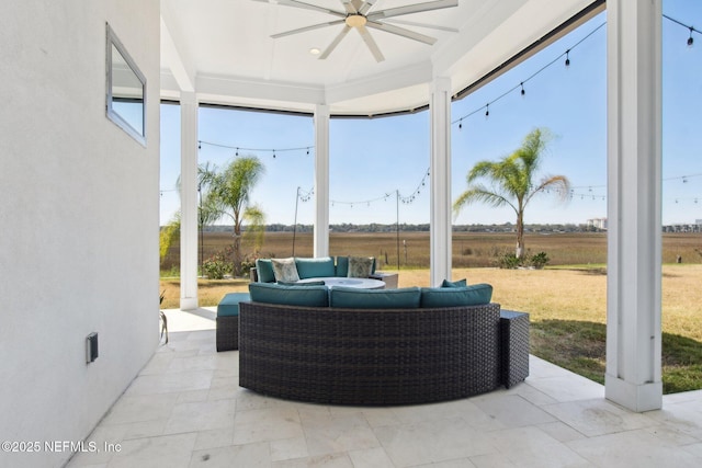 view of patio / terrace featuring a rural view, a ceiling fan, and an outdoor hangout area