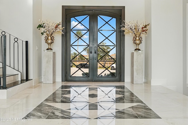 interior details featuring french doors and baseboards