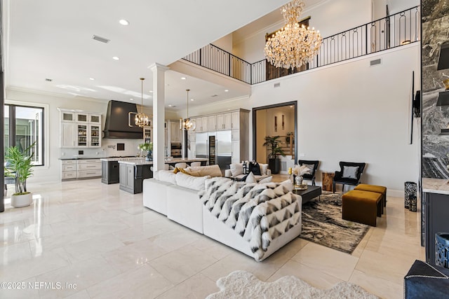 living area featuring visible vents, recessed lighting, crown molding, and an inviting chandelier