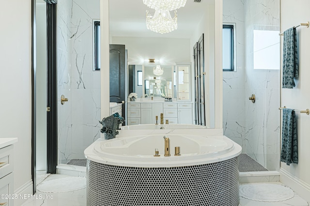 full bathroom with a marble finish shower, a garden tub, marble finish floor, and a chandelier