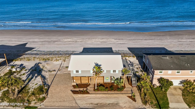 aerial view with a water view and a beach view