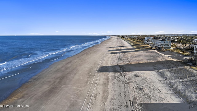 aerial view featuring a view of the beach and a water view