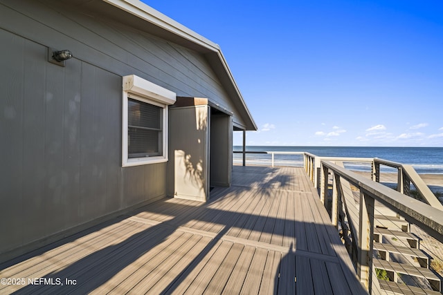 wooden terrace featuring a water view