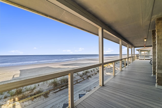 deck with a beach view and a water view