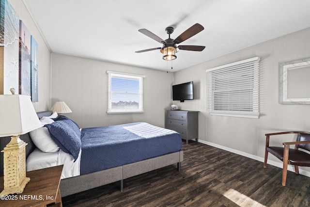 bedroom featuring a ceiling fan, baseboards, and wood finished floors