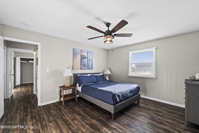 bedroom featuring ceiling fan, baseboards, and wood finished floors