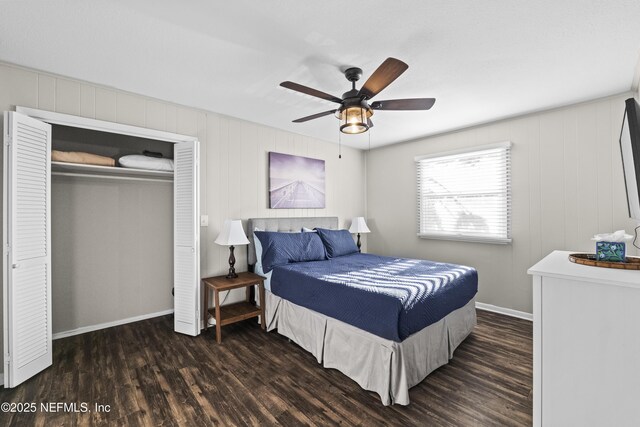 bedroom with a ceiling fan, wood finished floors, a closet, and baseboards